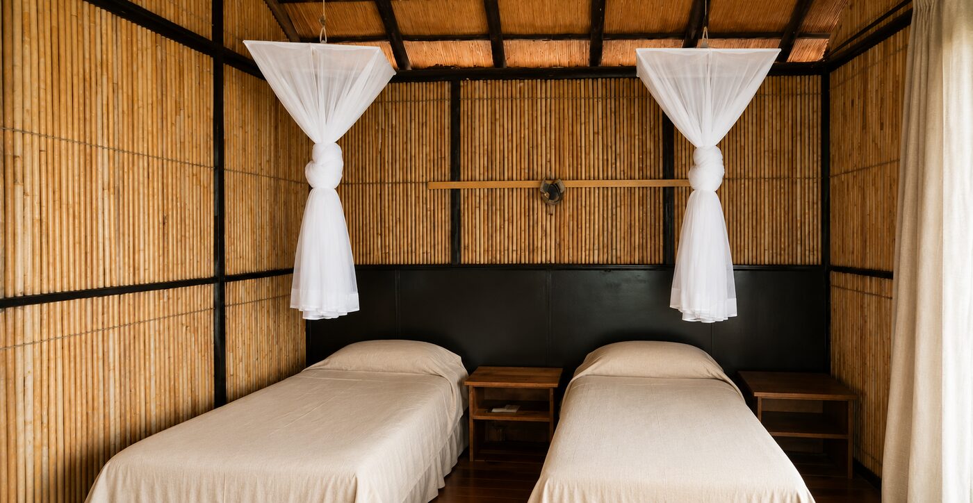 Twin-bed room with mosquito nets at Nhlonhlela Bush Lodge