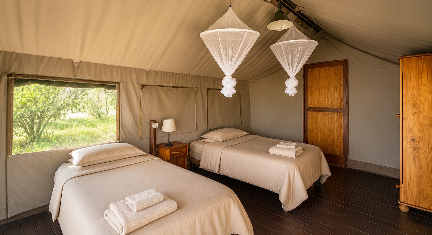 Twin-bed interior of a Mantuma safari tent with mosquito nets